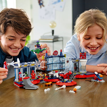 Kids enjoying LEGO® Marvel Spider-Man Attack on the Spider Lair set, playing in a vibrant superhero headquarters.