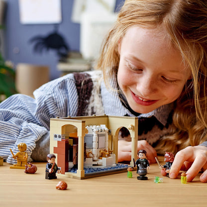 Child playing with LEGO® Harry Potter Hogwarts Potion Mistake Set 76386 in Hogwarts bathroom, crafting magical scenes.