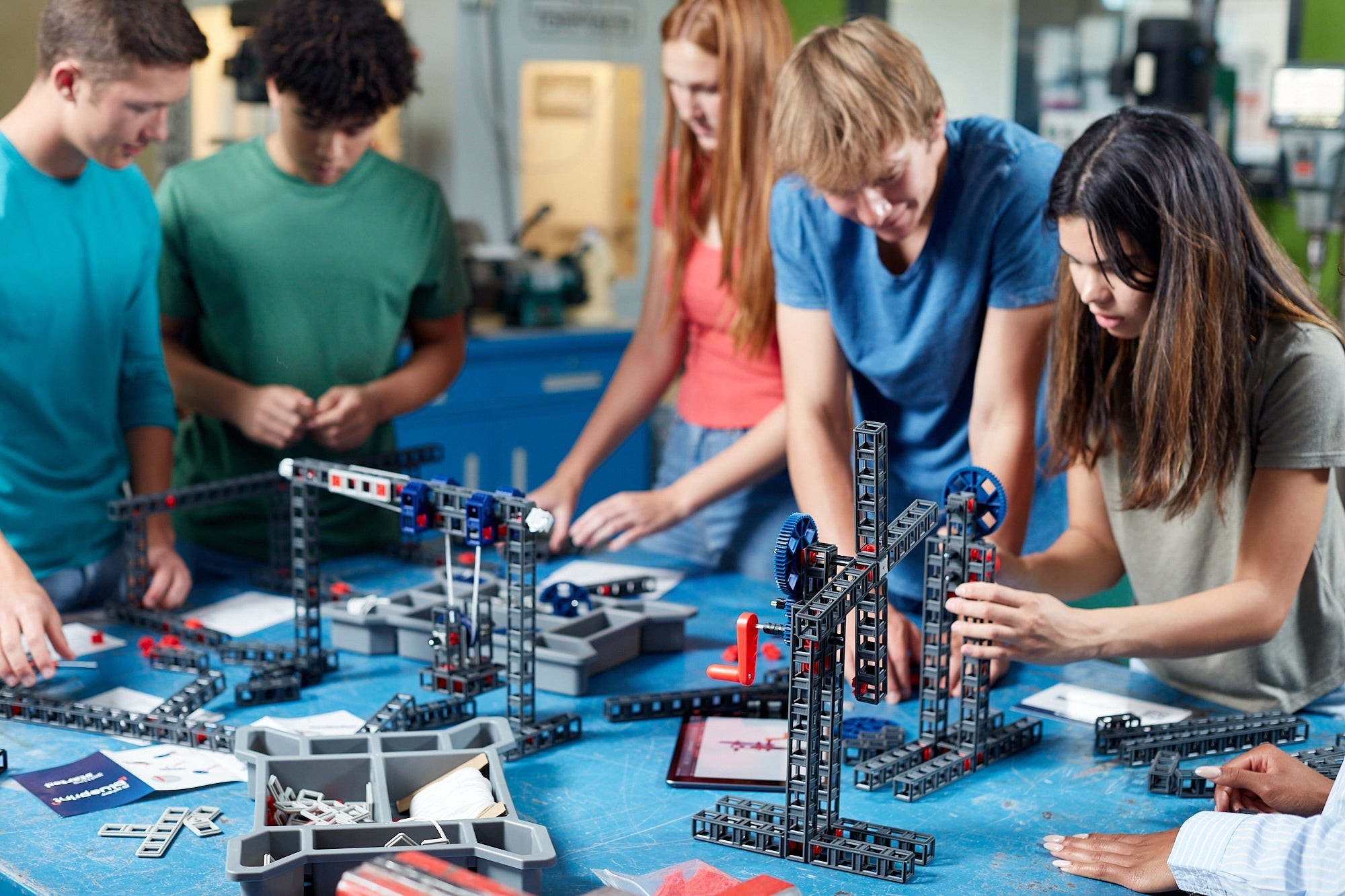 Students collaborating on engineering projects using building sets, focusing on creativity and teamwork in a classroom setting.