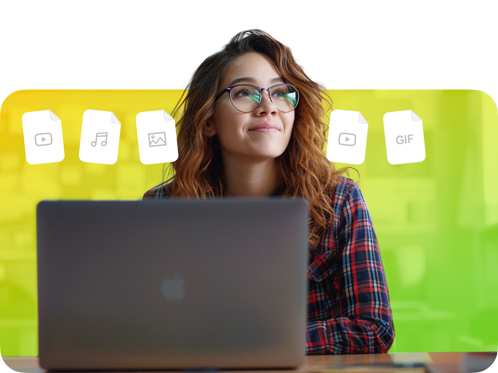Young woman with glasses smiling at laptop with icons representing different media files in the background.