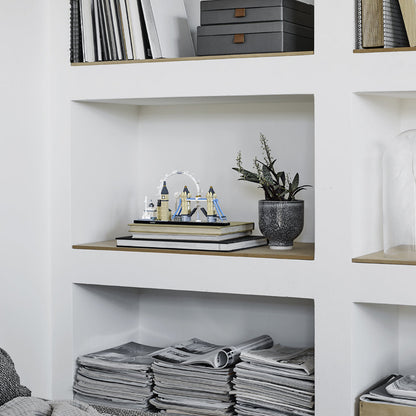 LEGO Architecture London skyline model featuring iconic landmarks on a bookshelf with decor and magazines.