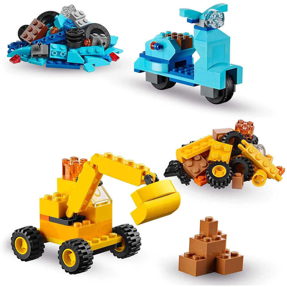 Colorful LEGO® creations including a blue scooter, construction vehicle, and assorted bricks, perfect for imaginative play.