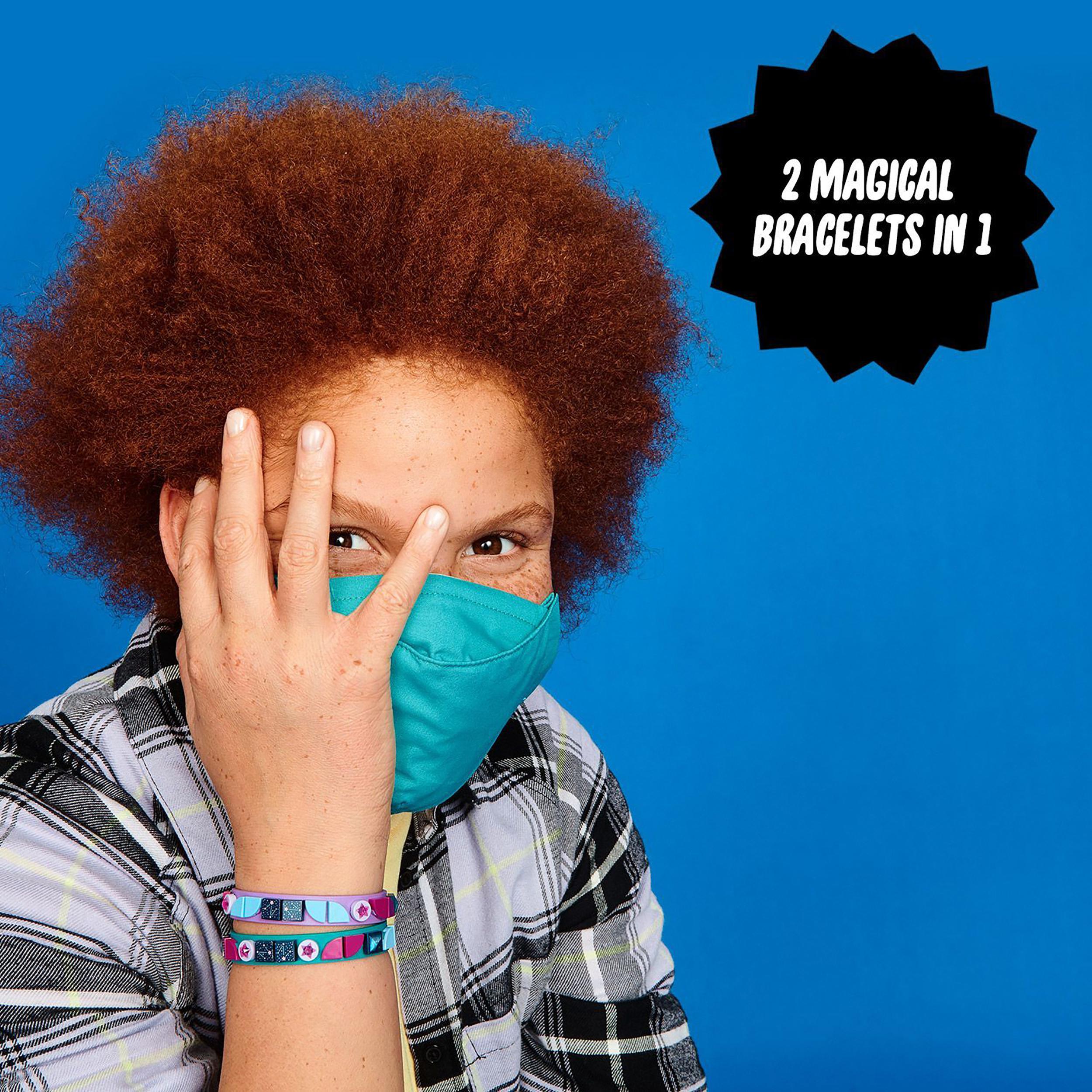 Child wearing teal mask and two colorful LEGO DOTS bracelets against a blue background, showcasing creative accessory fun.