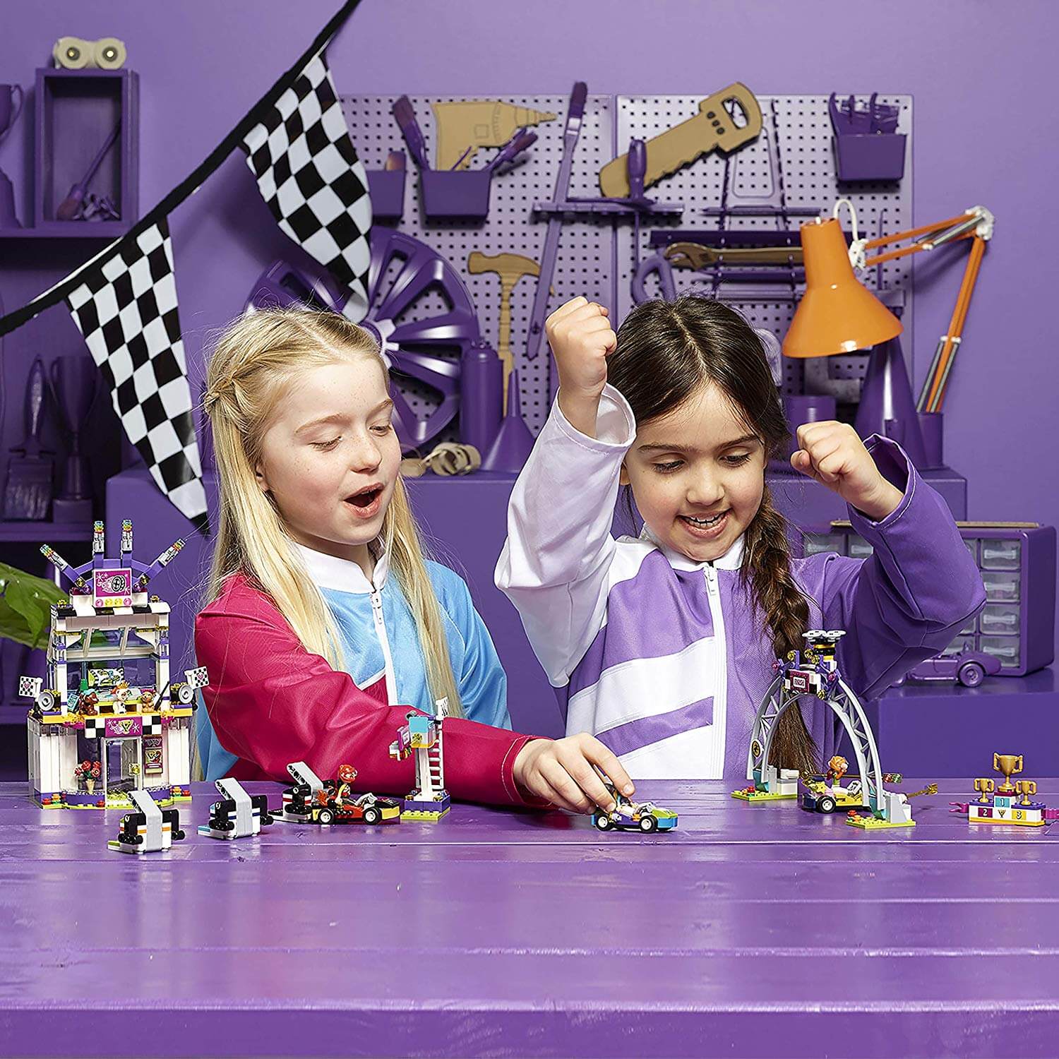 Two children enjoying the LEGO® FRIENDS The Big Race Day playset, celebrating go-kart racing fun in Heartlake City.