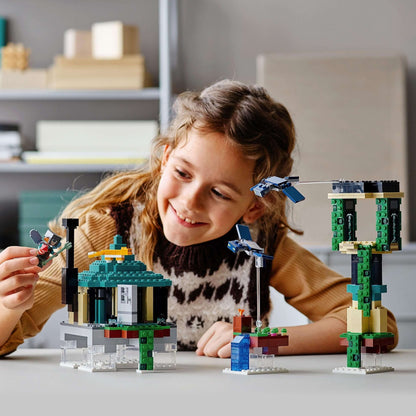 Girl joyfully playing with LEGO® Minecraft The Sky Tower Building Set 21173, exploring imaginative sky environments.