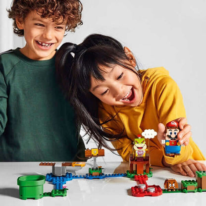 Kids enjoying the LEGO Super Mario Adventure Starter Course Set 71360 with Mario and Bowser Jr. figures.