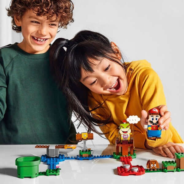 Kids enjoying the LEGO Super Mario Adventure Starter Course Set 71360 with Mario and Bowser Jr. figures.