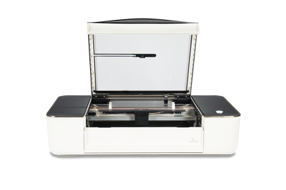 Glowforge Plus laser cutter with open lid and high-tech components, ideal for engraving and cutting projects.