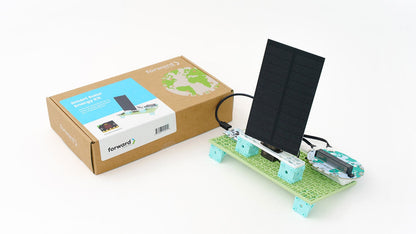 A functioning solar panel prototype built with modular green and blue blocks, connected to a micro:bit interface. The product’s cardboard packaging, labelled "Smart Solar Energy Kit", sits alongside the model on a white background.