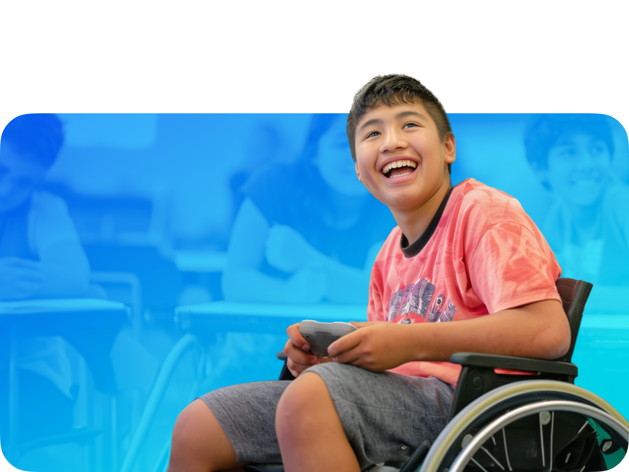 Happy boy in a wheelchair enjoying gaming in a classroom setting, promoting inclusivity and joy.