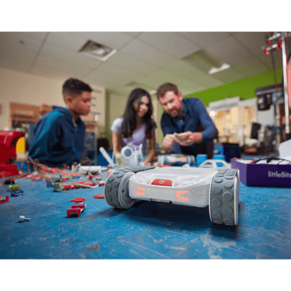 Students and instructor engaging with Sphero RVR+ robot in a creative learning environment with robotics components.