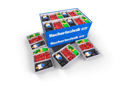 fischertechnik CLASS SET Basics for elementary school, featuring colorful building blocks and figures in organized trays.