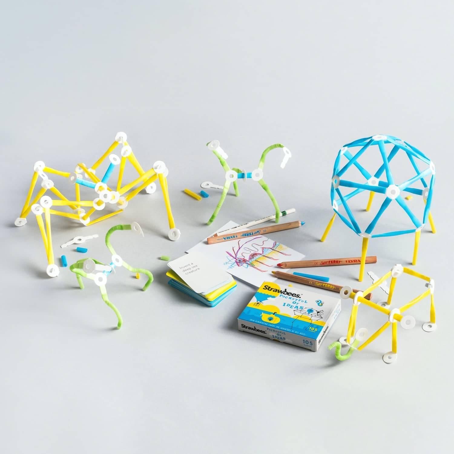 Imagination Kit featuring colorful building models, sketchbook, challenge cards, and art supplies for creative play.