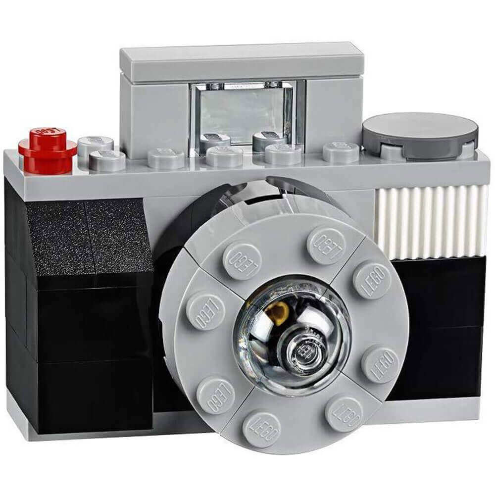LEGO camera model featuring detailed design, black and gray bricks, and realistic lens for creative building fun.
