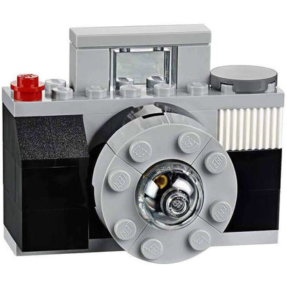 LEGO camera model featuring detailed design, black and gray bricks, and realistic lens for creative building fun.