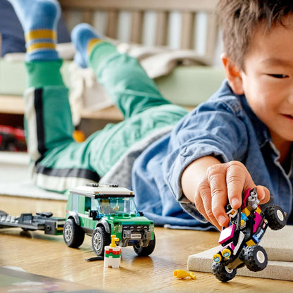 Child playing with LEGO® City Race Buggy Transporter, featuring off-roader and Baja buggy on the floor.