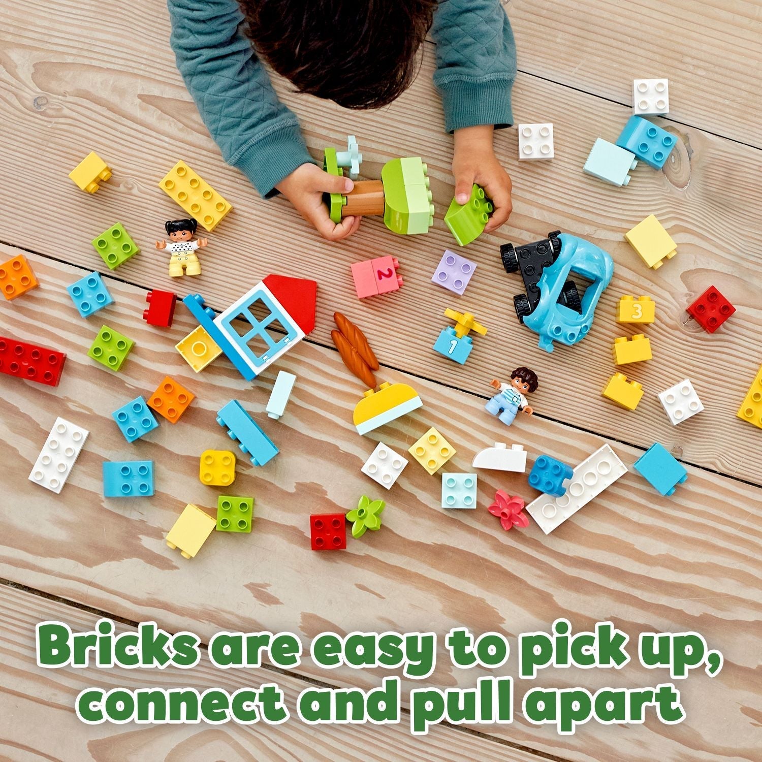 Child playing with LEGO® DUPLO Classic Brick Box Set 10913, showcasing colorful bricks for creative toddler play.