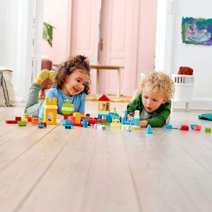 Children playing with LEGO® DUPLO Classic Deluxe Brick Box Set, featuring colorful bricks, a car, and fun accessories.