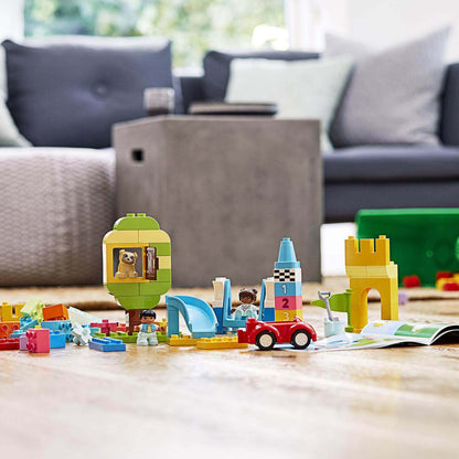 LEGO® DUPLO Classic Deluxe Brick Box Set 10914 with colorful bricks, car, and characters on a playroom floor.