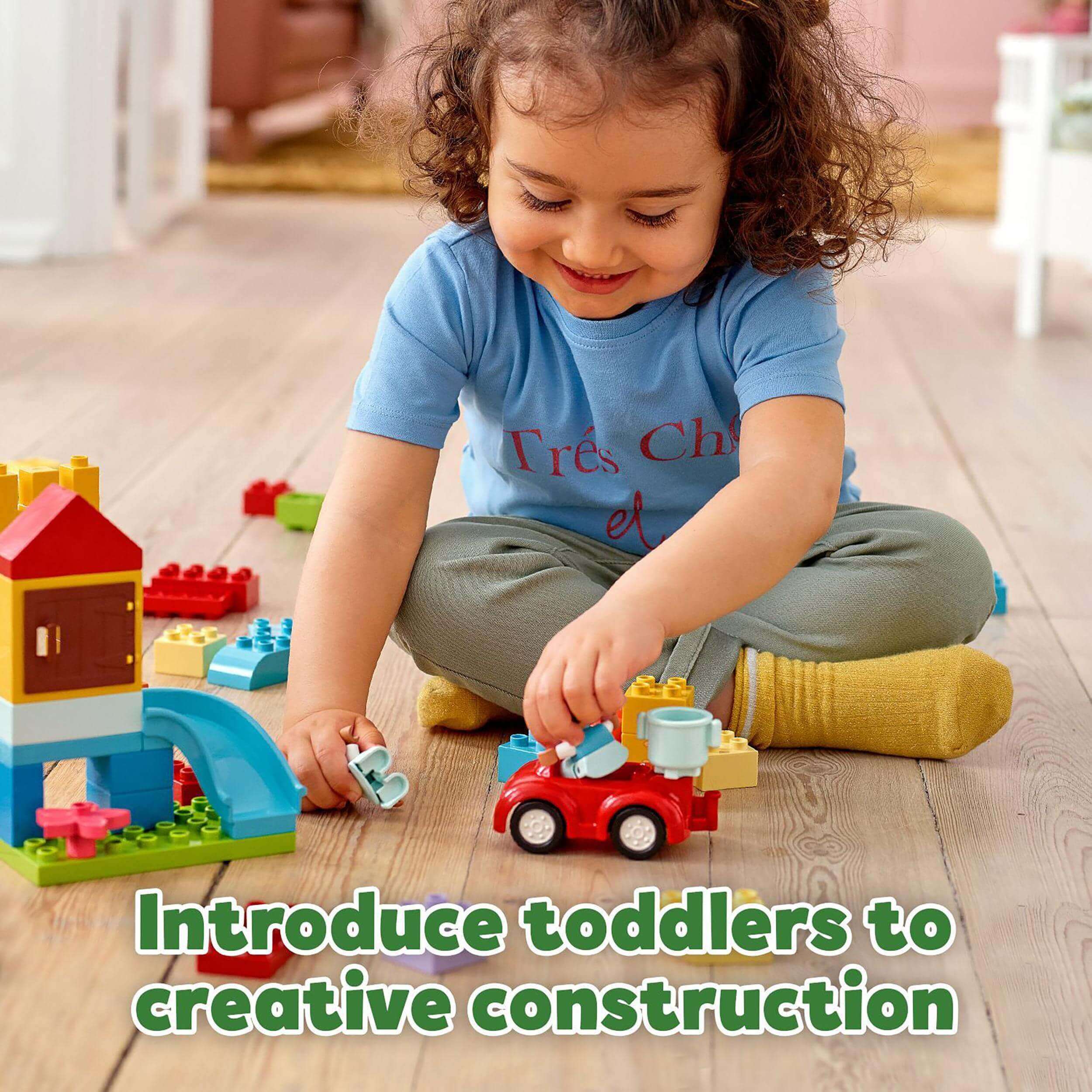 Toddler playing with LEGO® DUPLO Classic Deluxe Brick Box Set, building and exploring creative construction.