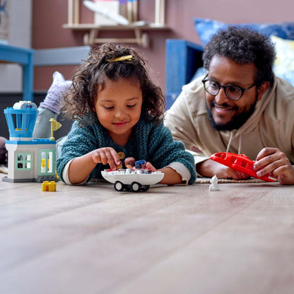 Child and parent playing with LEGO® DUPLO Town Aeroplane & Airport Set 10961, enjoying imaginative air travel adventures.
