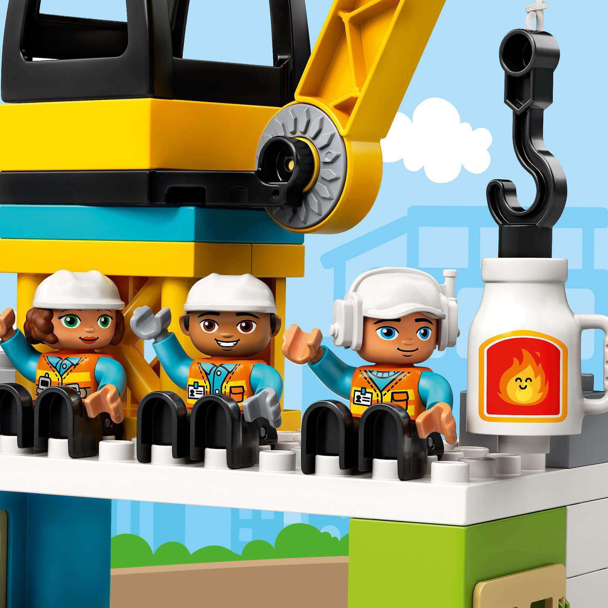 LEGO DUPLO construction set with three diverse character figures at a tower crane site.