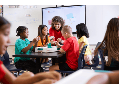 Students engaged in hands-on science activities with LEGO® Education kits in a classroom setting.