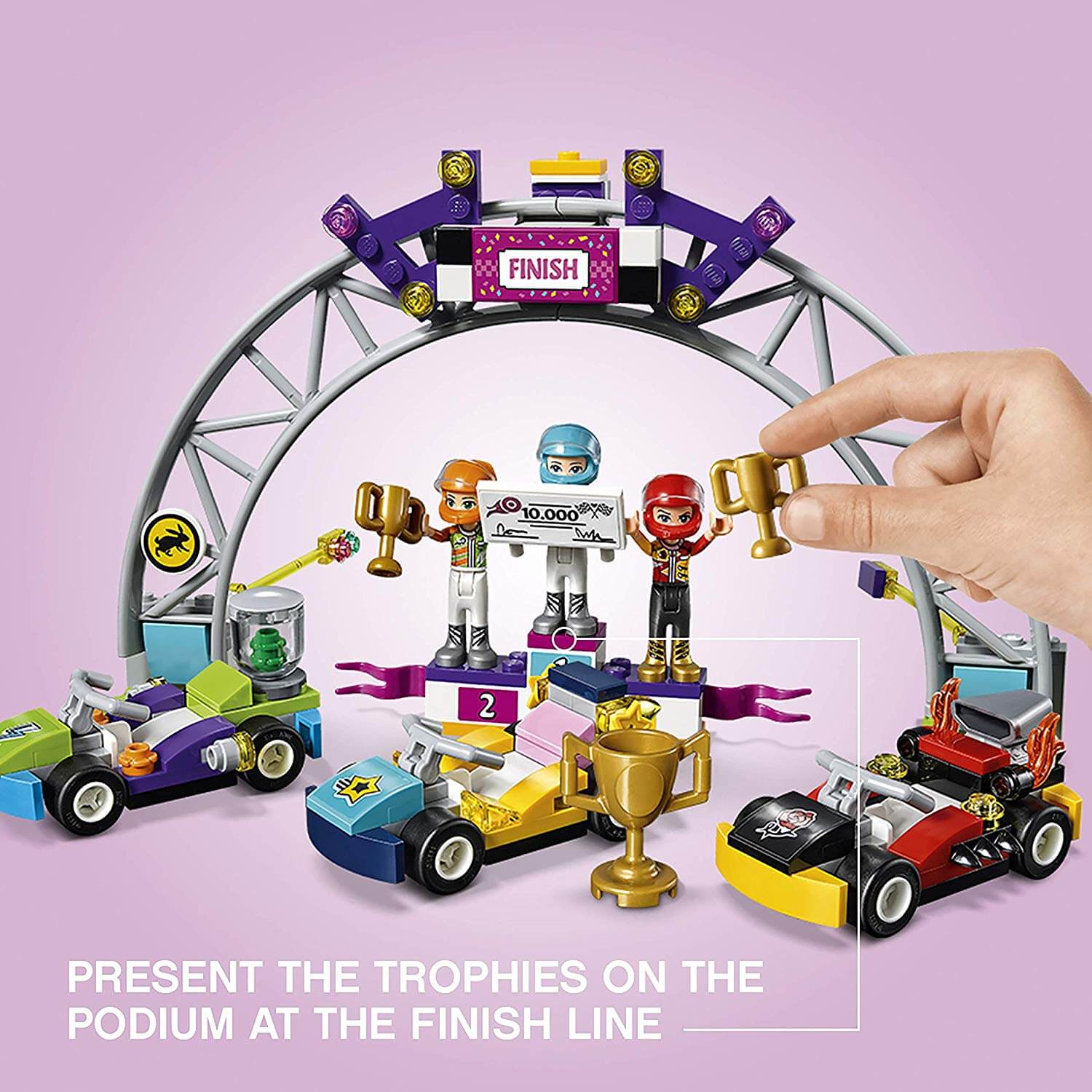 LEGO® Friends Heartlake The Big Race Day set showcasing go-kart finish line with trophies and mini-figures celebrating.