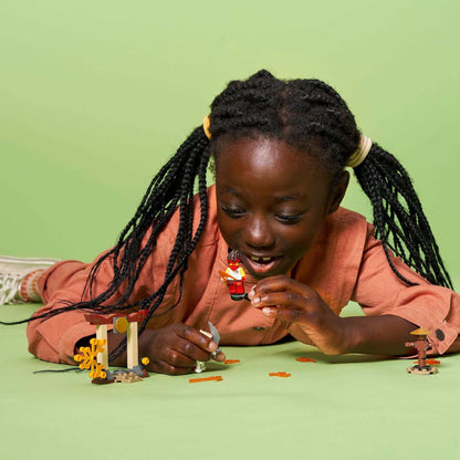 Child playing with LEGO® NINJAGO set, enjoying the action of Kai vs. Skulkin in an engaging scene.