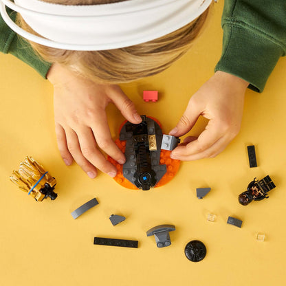 Child building with LEGO® NINJAGO Spinjitzu Burst Cole Spinner Toy 70685, featuring Cole's spinner and accessories.