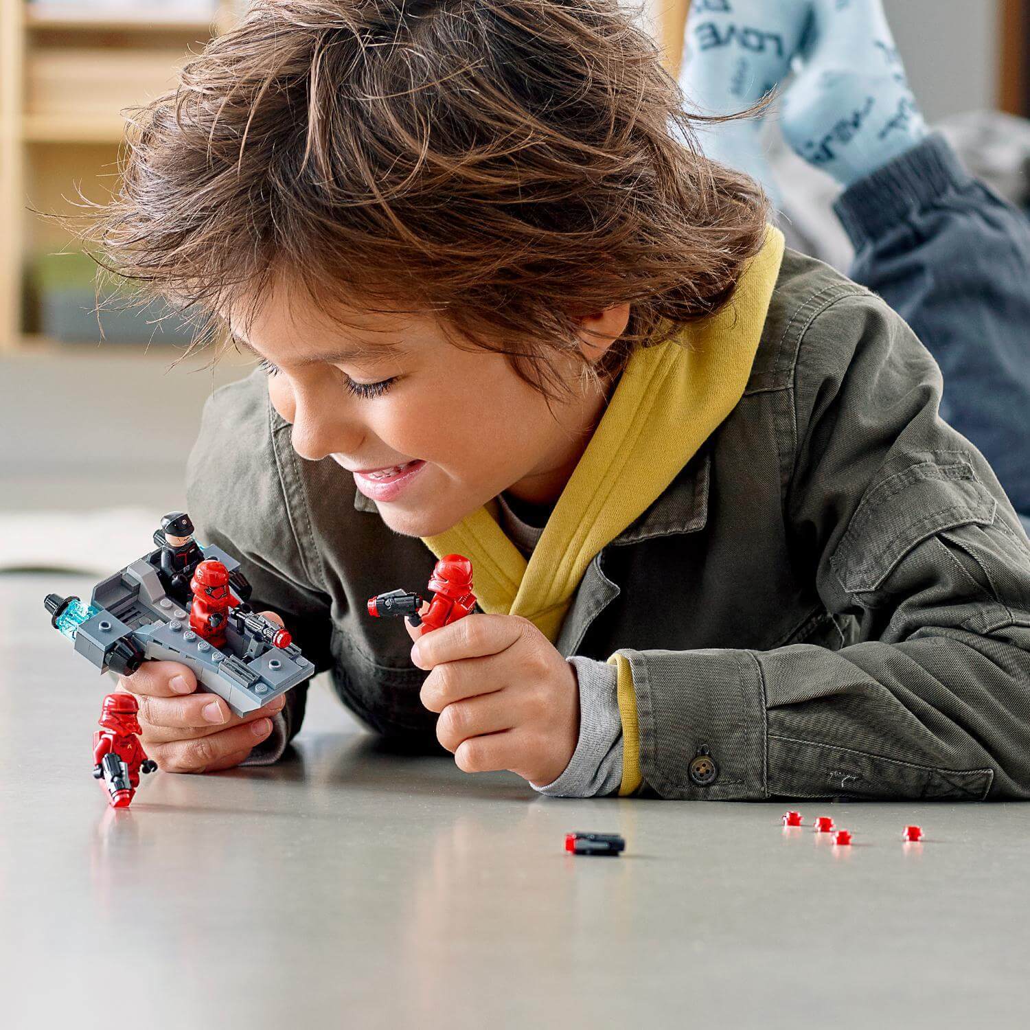 Child playing with LEGO® Star Wars Sith Troopers Battle Pack, building an army of First Order troopers.