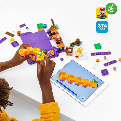 Child building with LEGO® Super Mario Poison Swamp Set 71383 and tablet, showcasing 374 pieces and exciting gameplay.