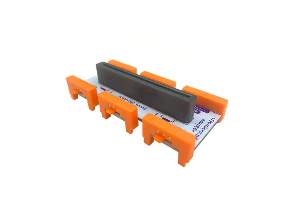 littleBits micro:bit Adapter for enhancing learning with micro:bit and coding, featuring orange connectors.