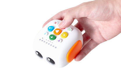 Child's hand holding the Tale-Bot coding robot, featuring colorful buttons for interactive storytelling and coding activities.