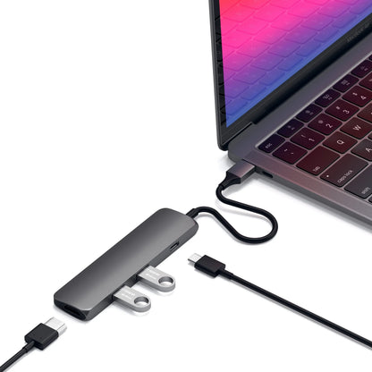 Satechi Type-C Slim Multi-Port Adapter connected to a laptop, showcasing USB ports and HDMI output.