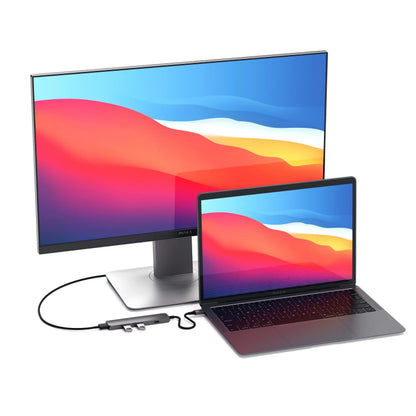 Satechi Type-C Slim Multi-Port Adapter connecting a MacBook to a monitor, showcasing 4K display capability.