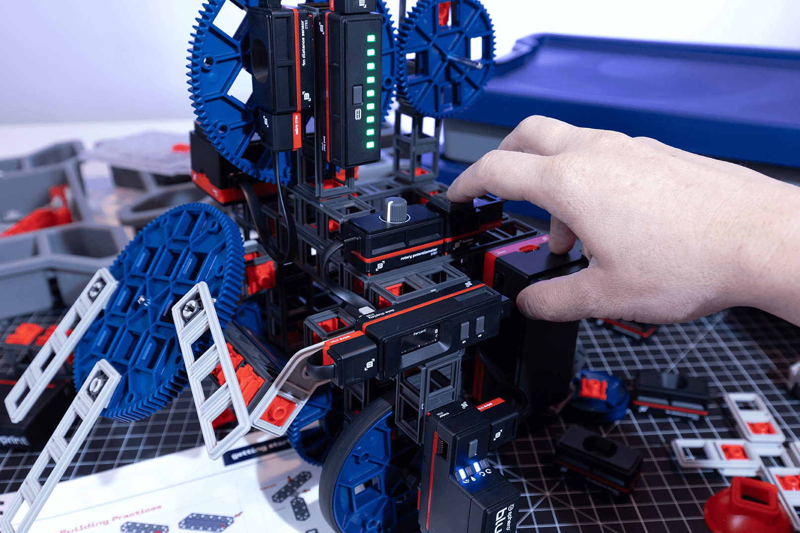 Hand adjusting components of the Sphero Blueprint Engineering Kit, showcasing engineering and robotics learning.
