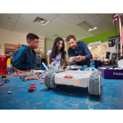 Students and instructor engaging with Sphero RVR+ robot in a creative learning environment with robotics components.