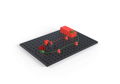 Colorful STEM electronics kit demonstrating basic circuitry on a black base, promoting sustainable learning.