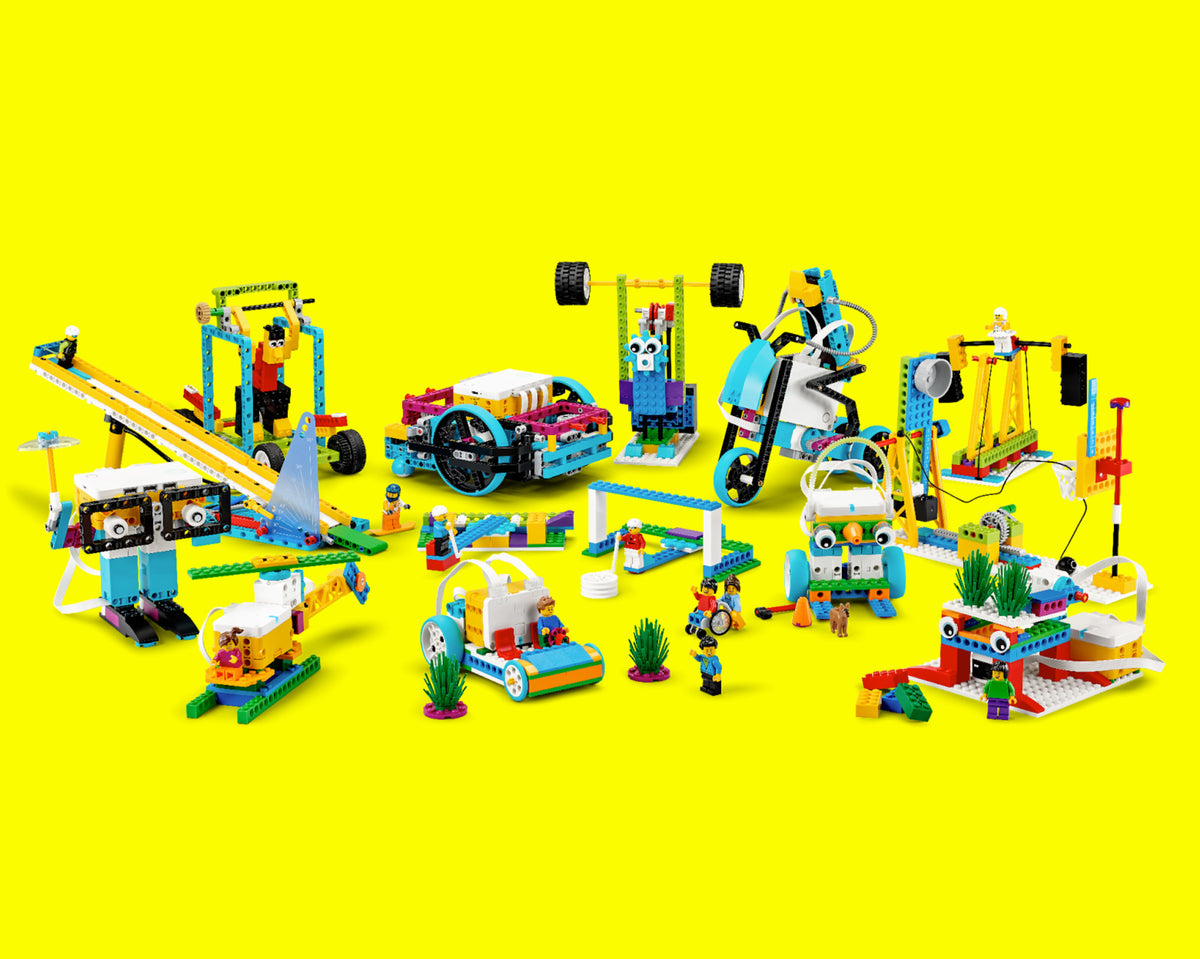 Colorful LEGO building set featuring cars, bikes, and playful constructions against a bright yellow background.